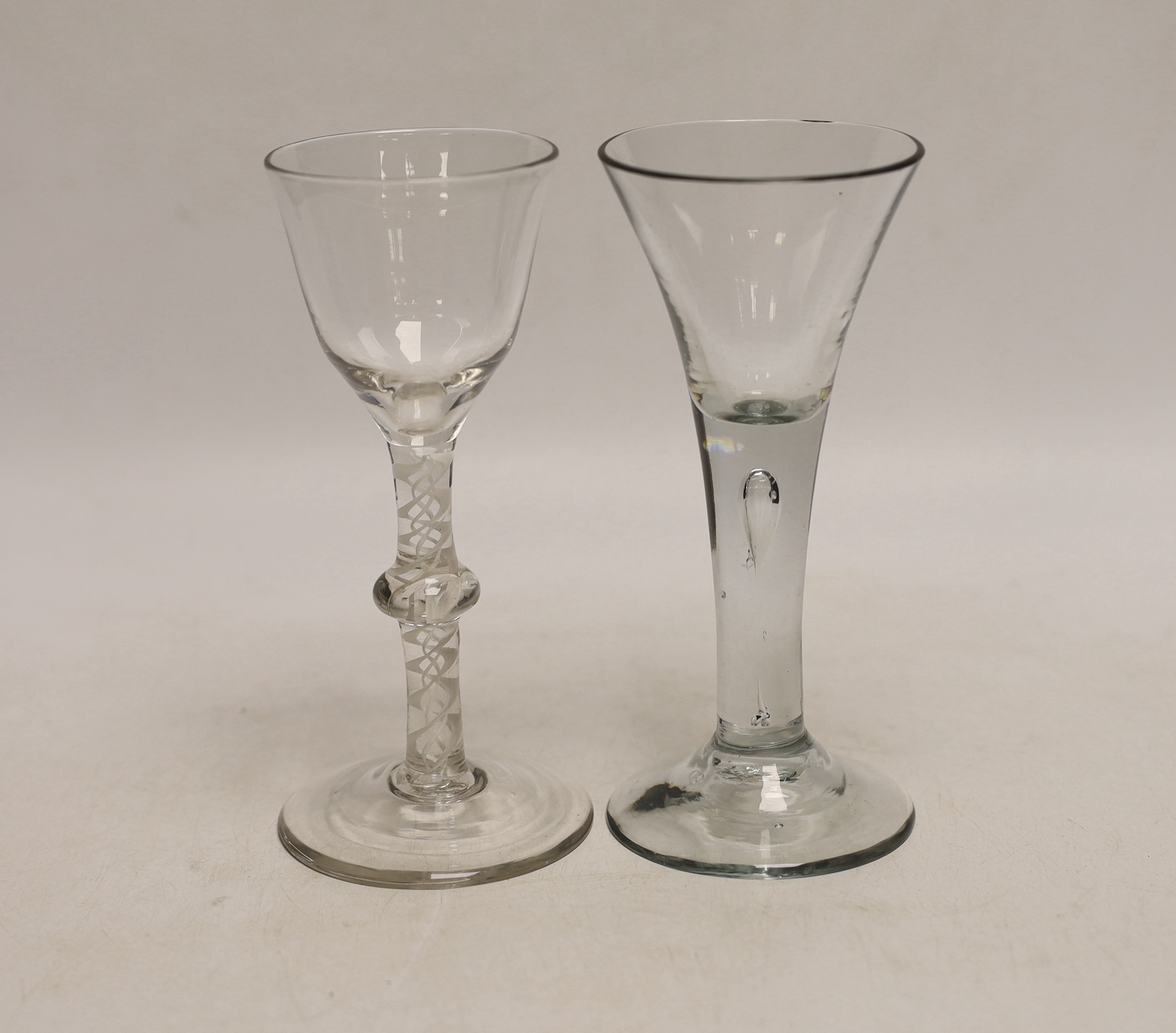 Two Georgian drinking glasses comprising, c.1760 opaque twist cordial glass and c.1750 drawn trumpet example, each 16cm high